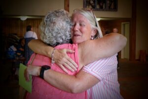 Hug with Paula Rudberg Lowe, Linda Newsom McKenney
